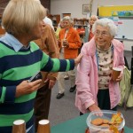 Mrs. Elsie Waters on right; Mrs. Susan Dechnik on left; fast disappearing cookies on table