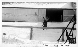 Joseph F. Yearly - shoveling snow in front of J.T. Evans sheds 1940